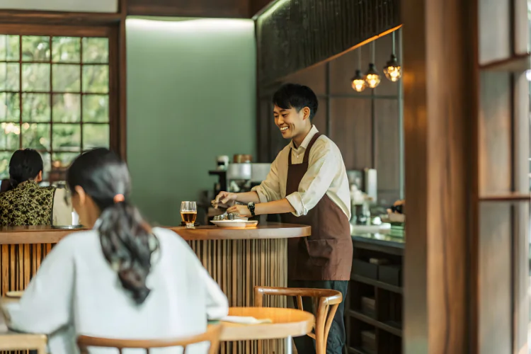 Server wearing apron working at restaurant