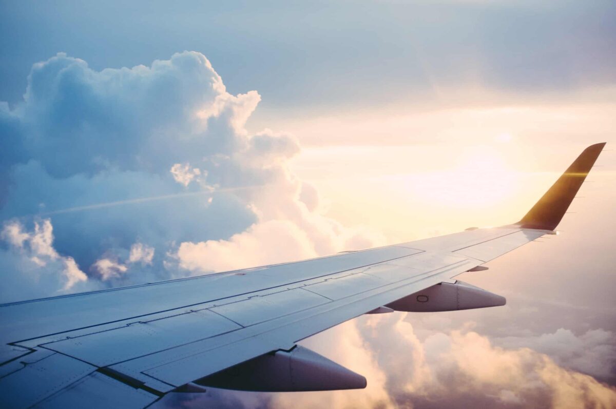 an airplane wing soaring above the clouds