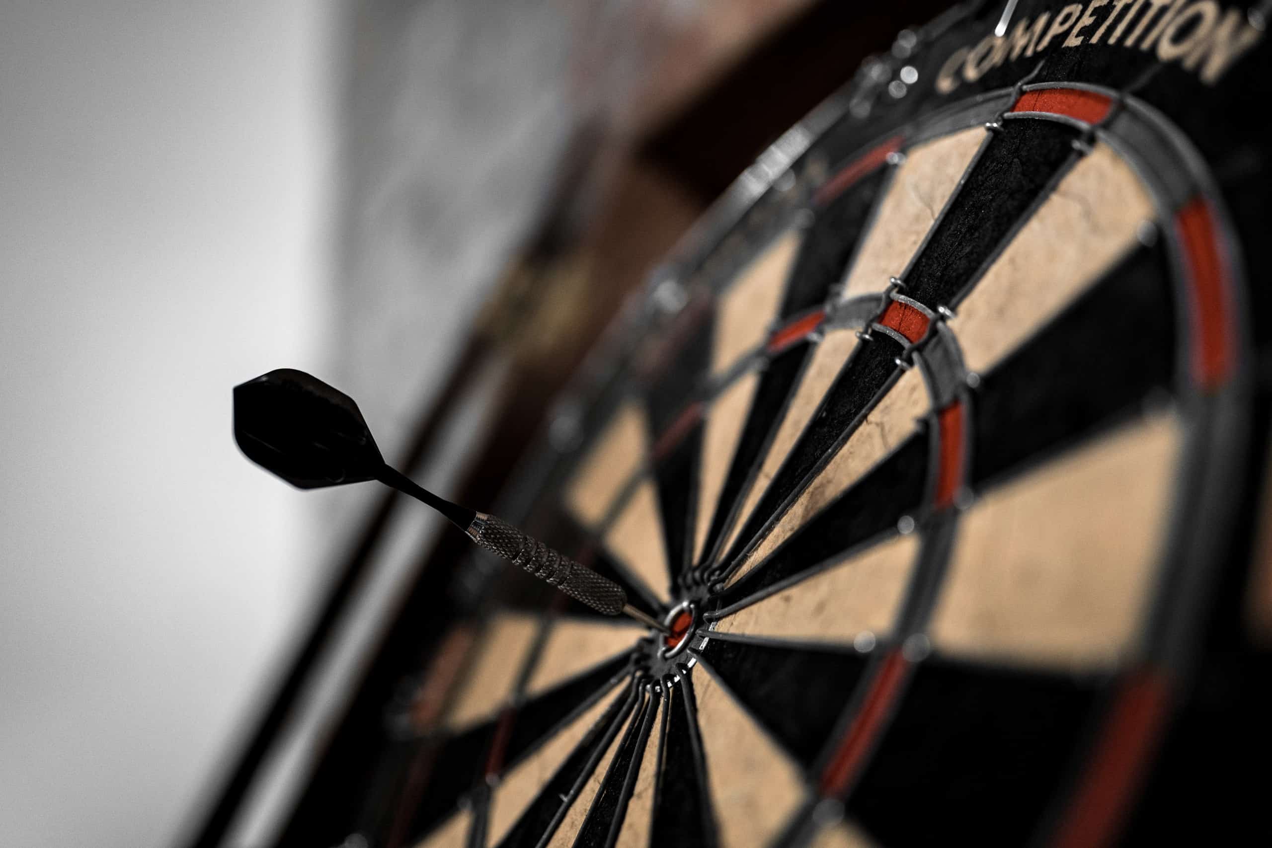 dartboard with dart in bulls eye
