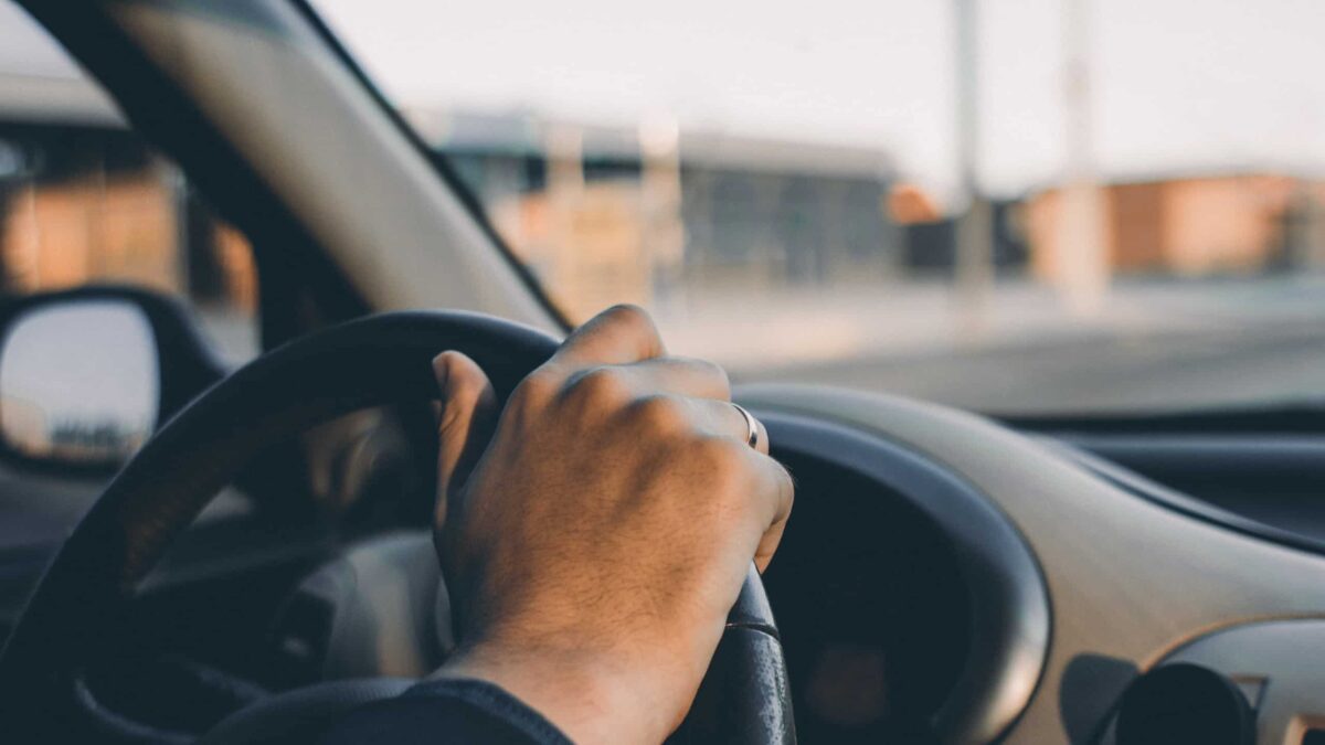 closeup of person behind the wheel of a car