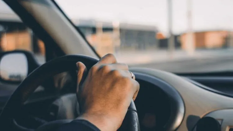 closeup of person behind the wheel of a car