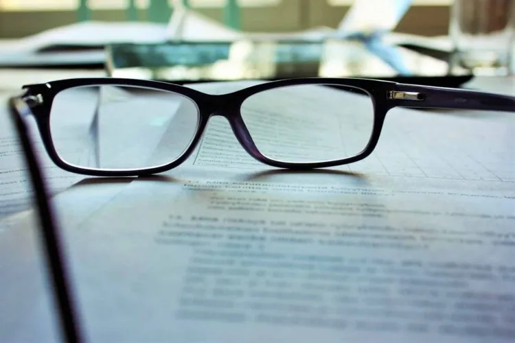 glasses resting on top of a contract