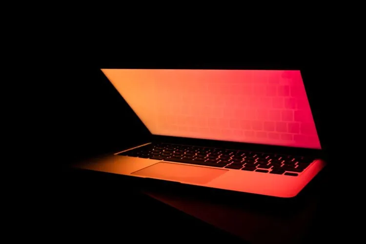 colourful laptop in a darkened room