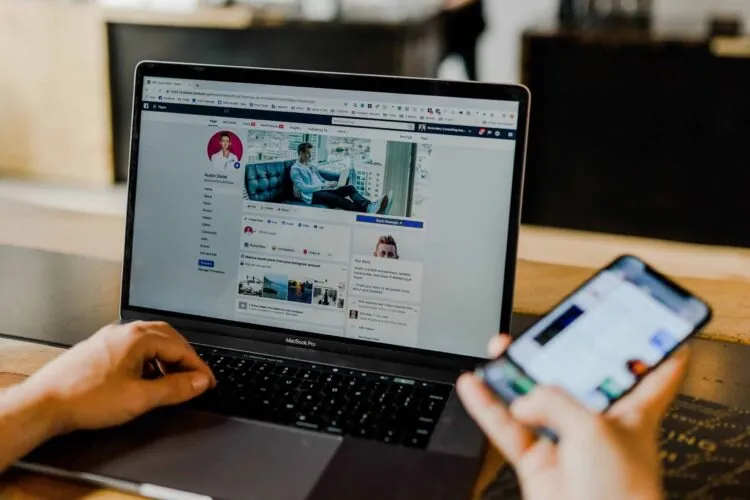 a person using facebook on their laptop and mobile device
