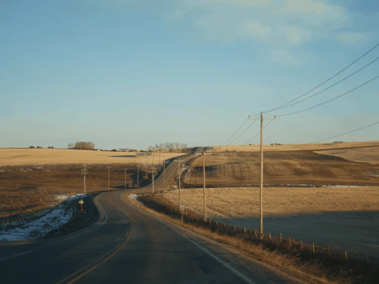 Road through Canadian prairie field