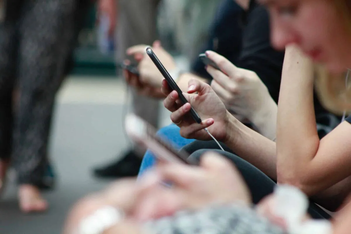 people on public transit using their mobile phones