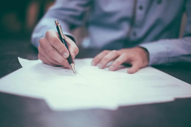 man signing business agreement