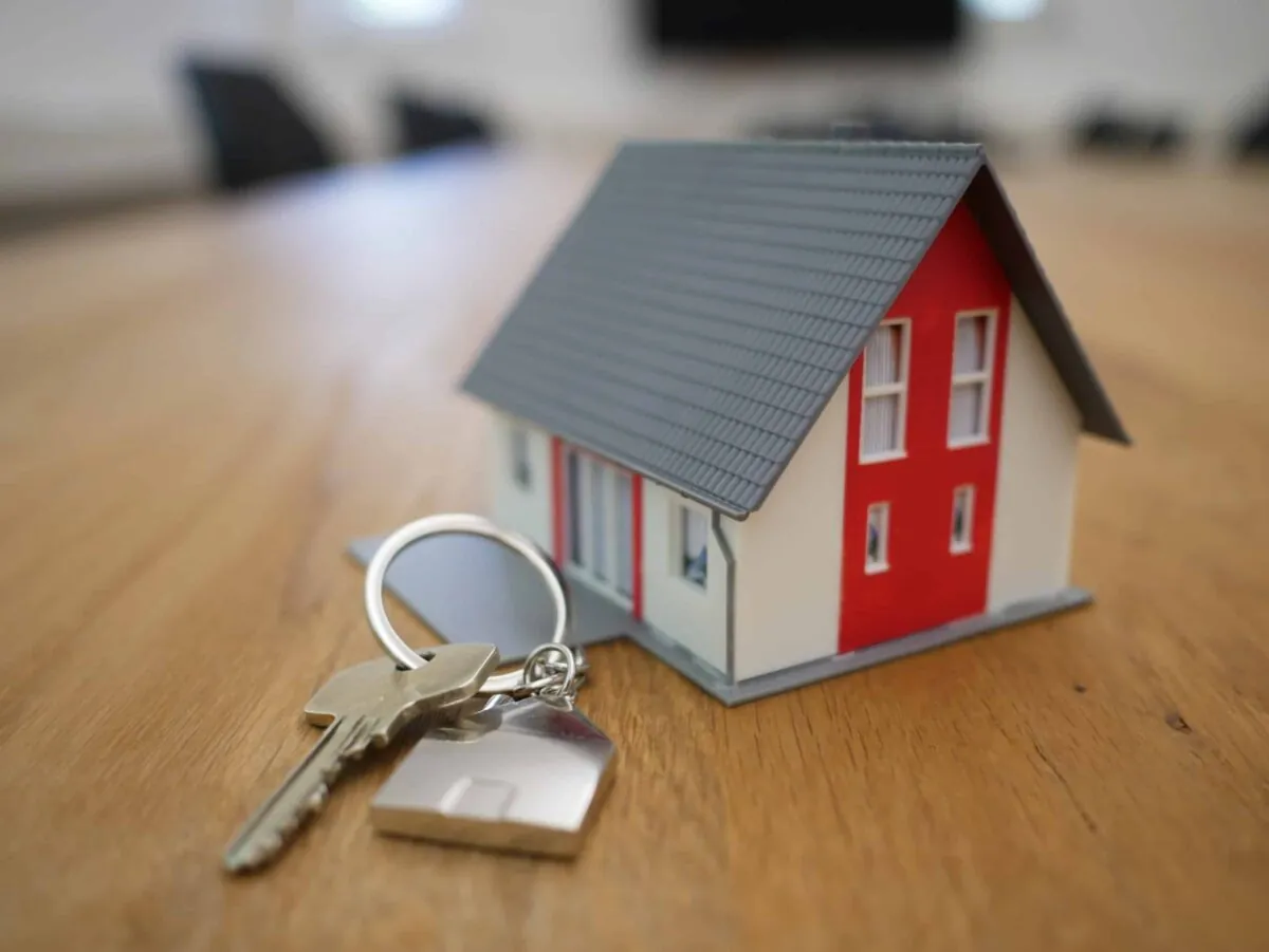 a miniature house with a set of keys