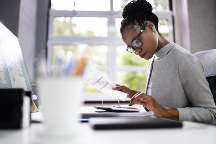 Accountant on calculator at desk