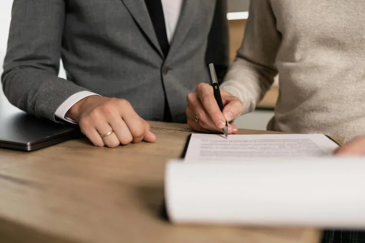 Two people signing paperwork | probate law