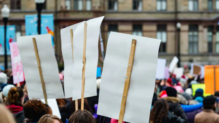 Group of people holding signs at a protest