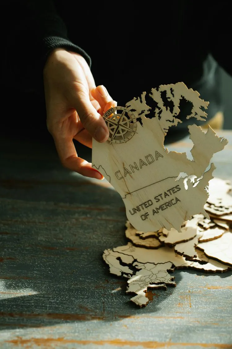 hand holding wooden map of North America