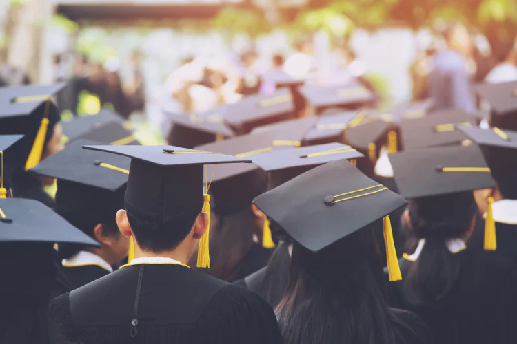 Group of graduates wearing caps and gowns at convocation ceremony