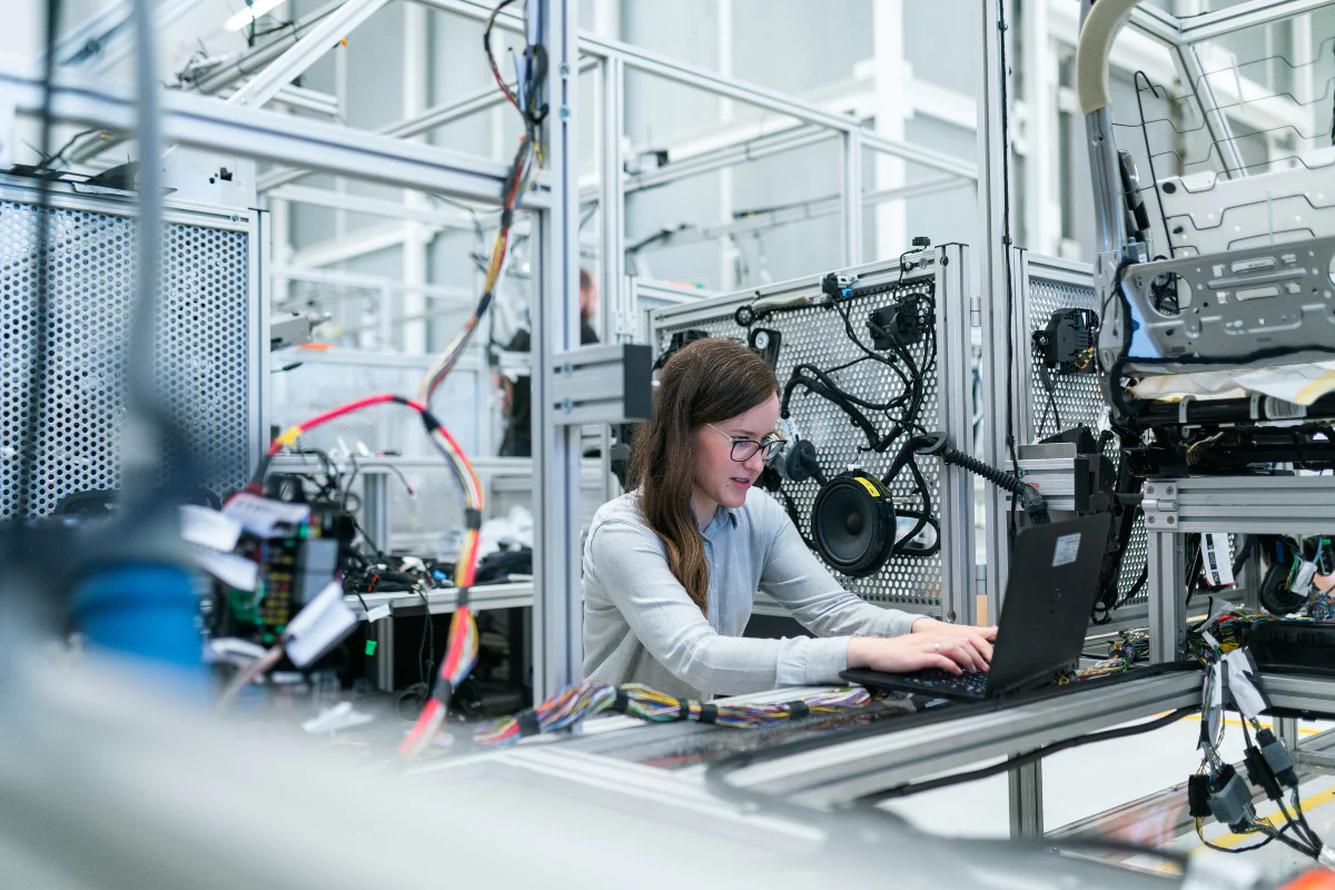 Female engineer at her workstation with laptop and other technology