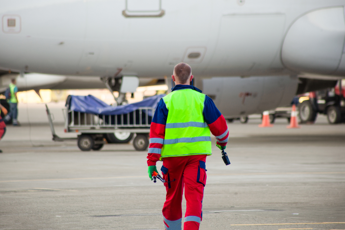 worker on tarmac at airport