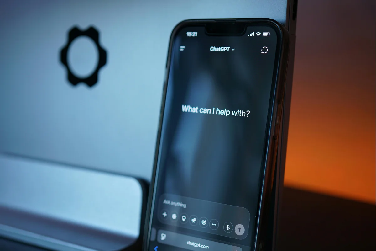 A phone in a dark room with ChatGPT showing on-screen