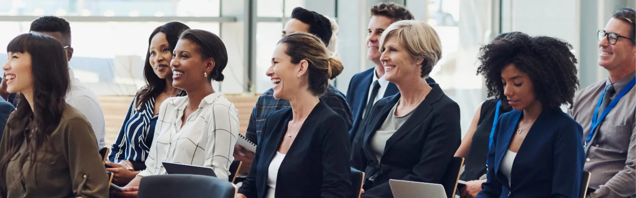 Smiling HR professionals at a seminar