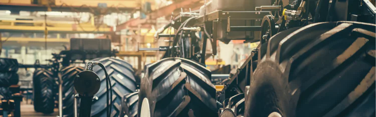 Large tractor tire treads at agricultural manufacturing facility