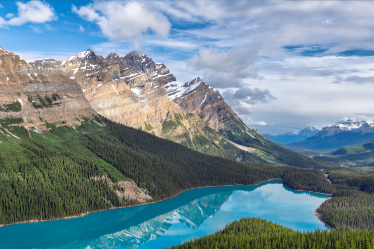 The Rocky Mountains overlooking a lake on a clear, sunny day in Banff National Park