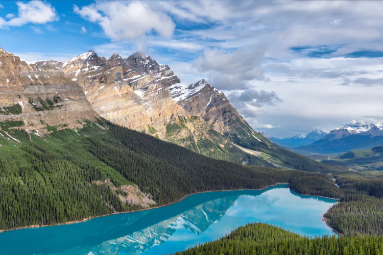 The Rocky Mountains overlooking a lake on a clear, sunny day in Banff National Park