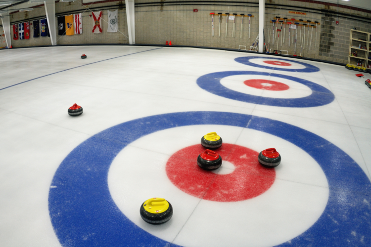 A photo of a curling rink, the house filled with rocks.