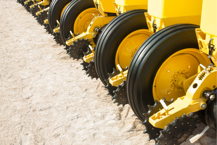 A close-up photo of a seeder's wheels in a field
