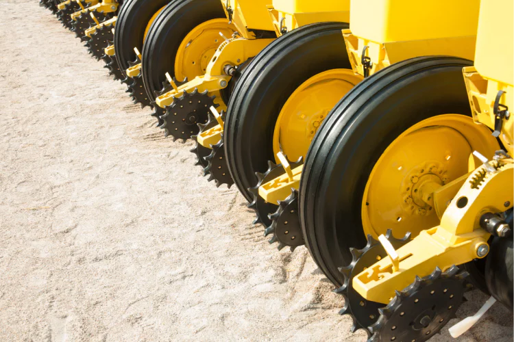 A close-up photo of a seeder's wheels in a field