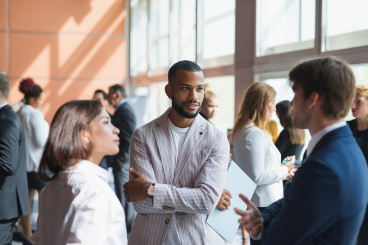 A diverse group of business people network at an event