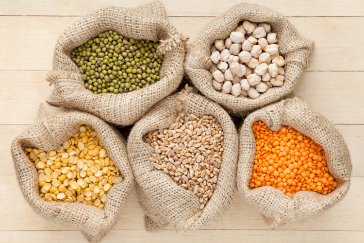 An overhead image of sacks of grains, including corn, chickpeas, mung beans and peas