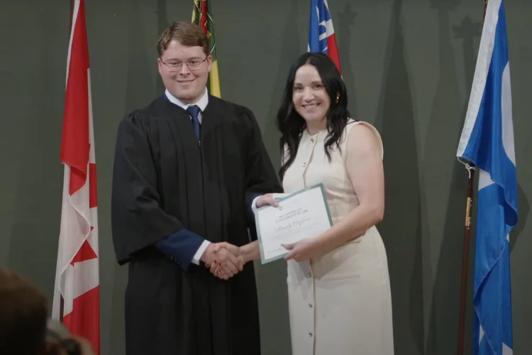 Law student Brody Olafson shaking hands with Erin Eccleston on stage
