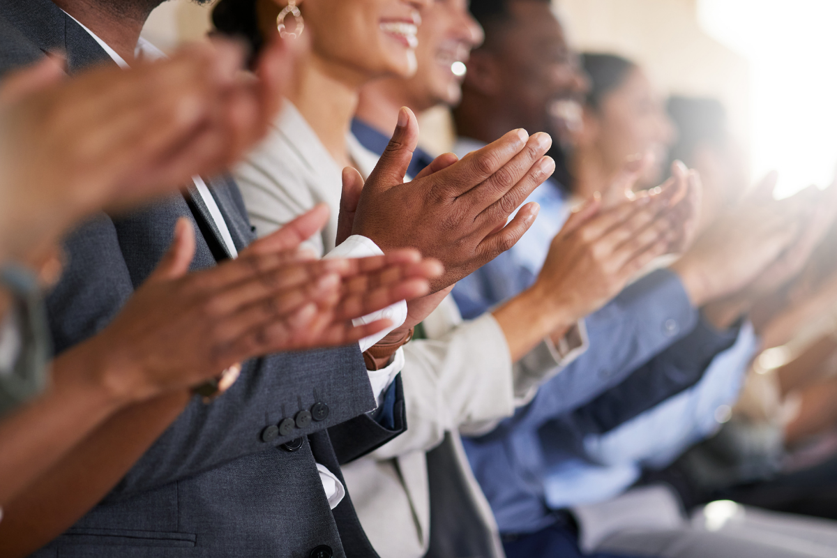 Group of business people clapping
