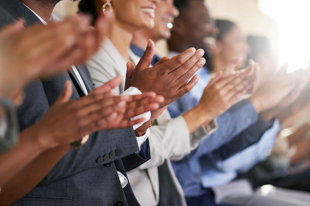 Group of business people clapping