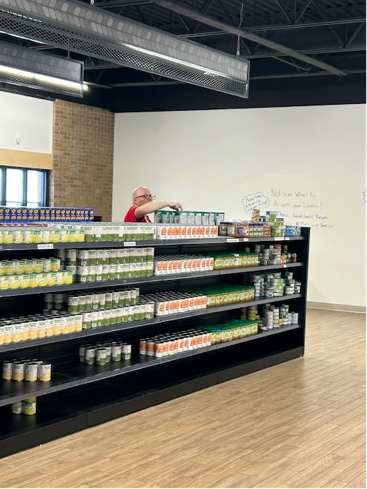 MLT Aikins staff stock food at the foodbank