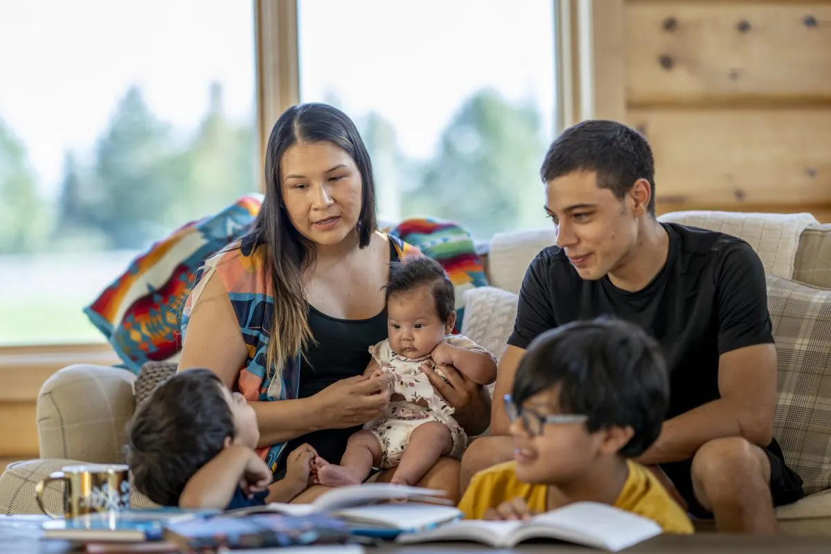 Indigenous mother and children sit together