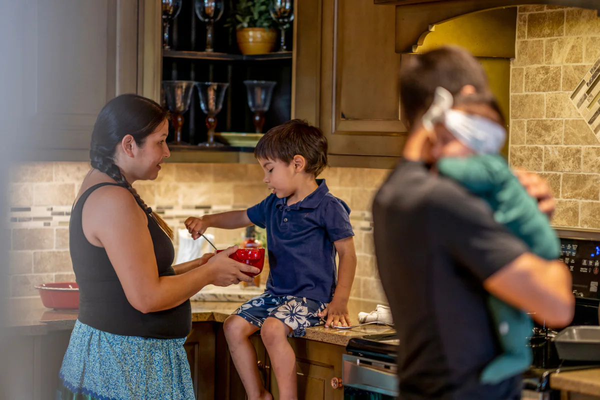 An Indigenous family in the kitchen cooking together