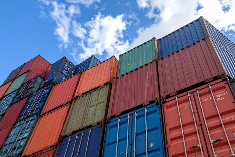 A stack of shipping containers on a clear sunny day