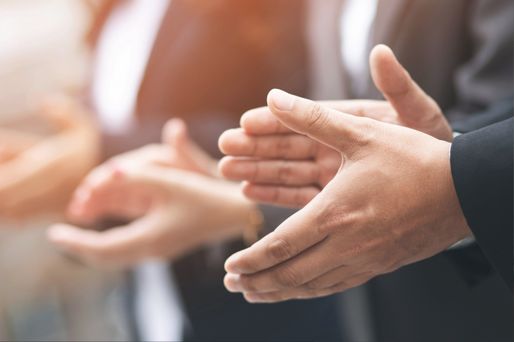 A group of people clapping, closeup on their hands