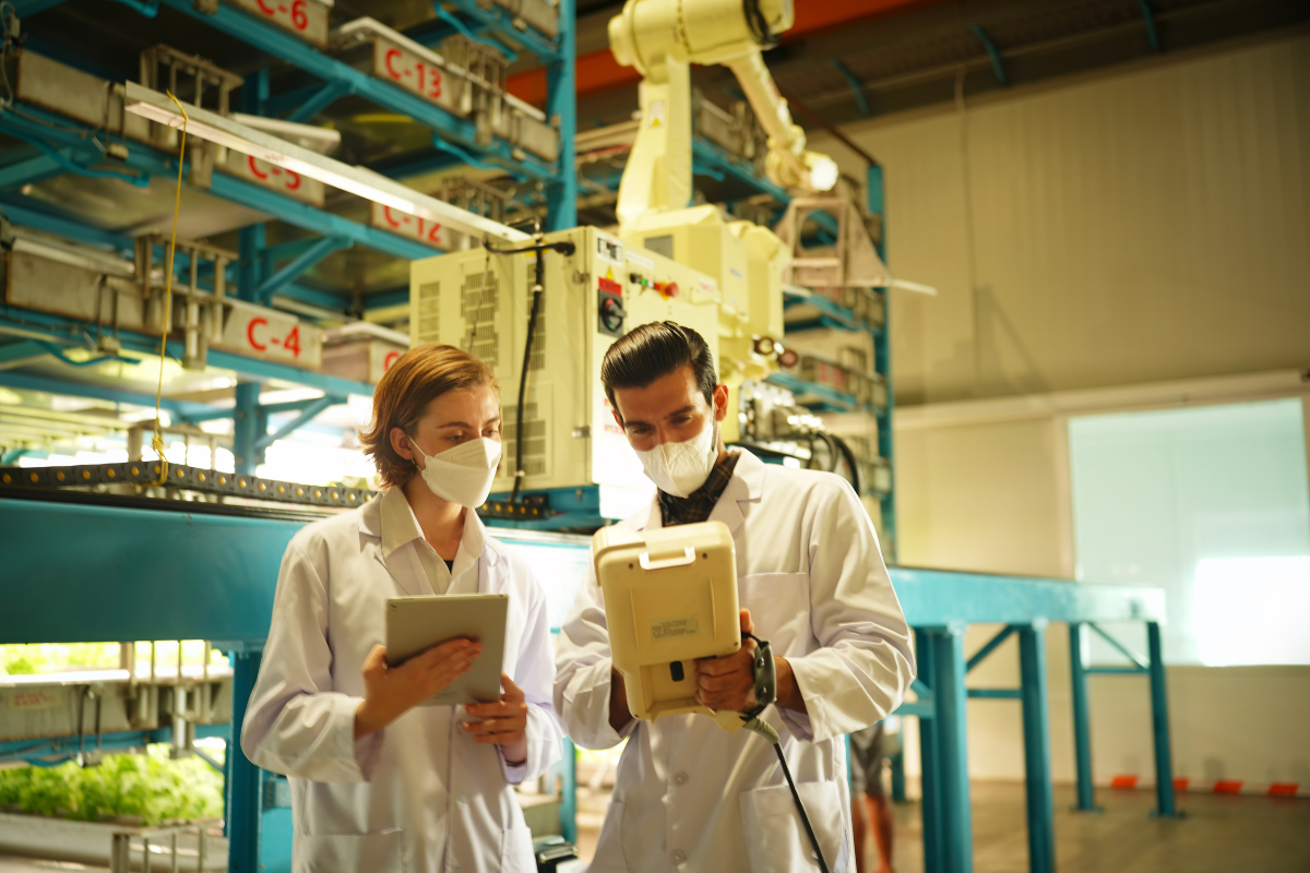 Two food scientists in a research facility looking at data on a tablet