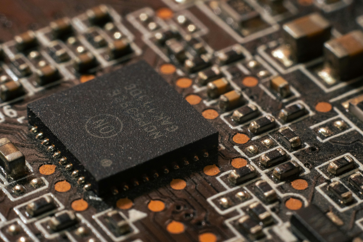 A closeup photo of a circuit board and computer chip