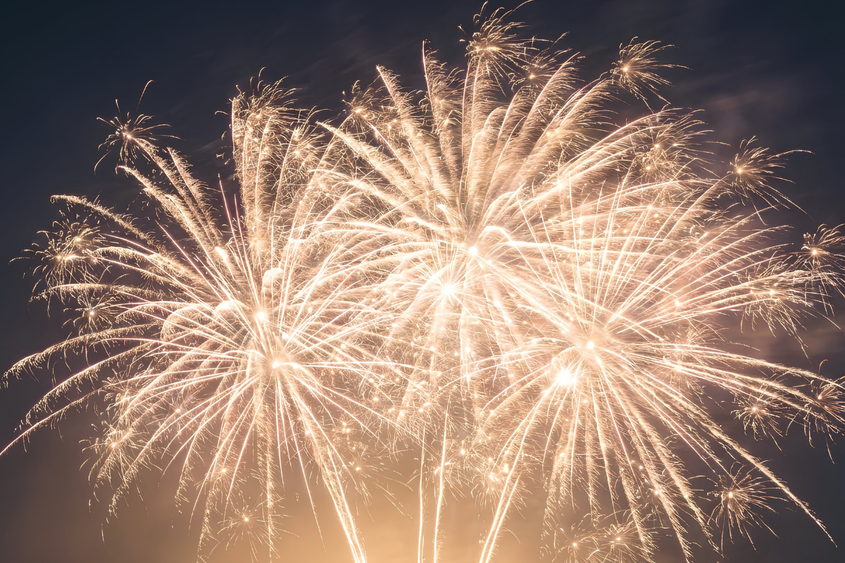 Golden fireworks against a night sky