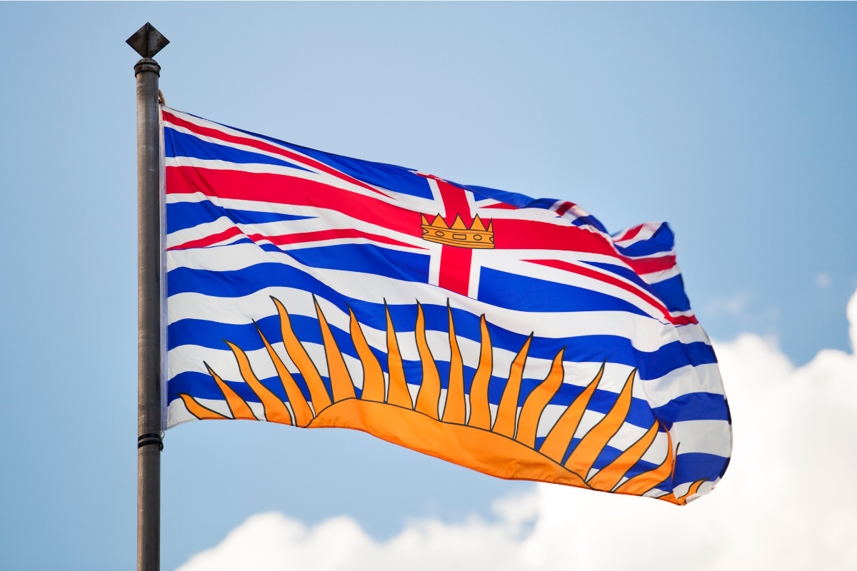 The British Columbia flag against a blue, sunny sky