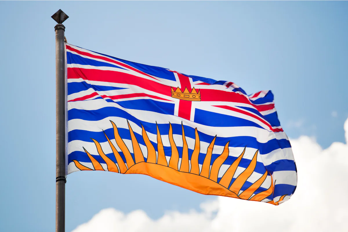 The British Columbia flag against a blue, sunny sky