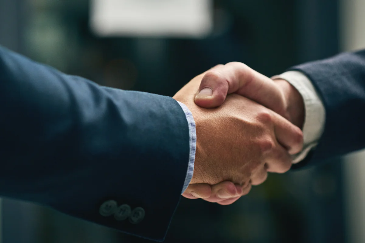 Two men in suits shaking hands