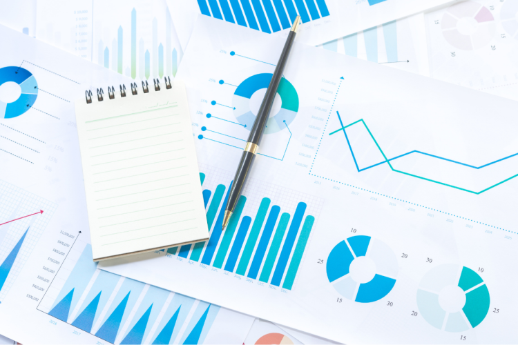 A stack of graphs, papers and a pen