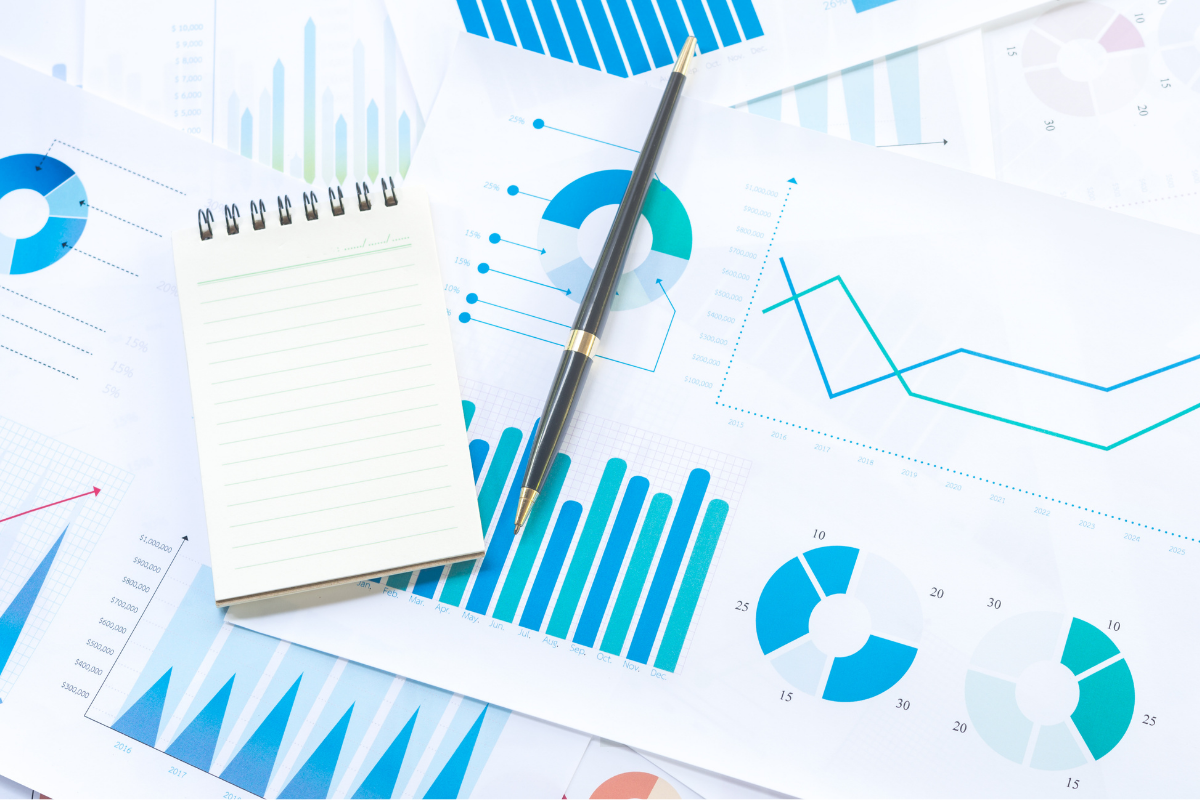 A stack of graphs, papers and a pen