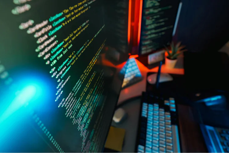 A dimly lit computer monitor with lines of code displayed on it