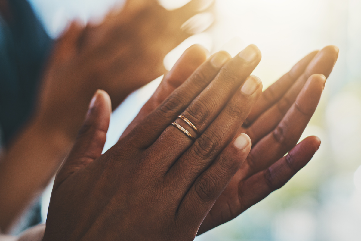 Hands clapping in the sunshine