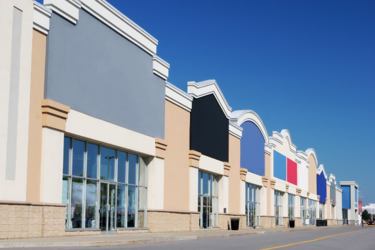 Row of colourful storefronts in a strip mall