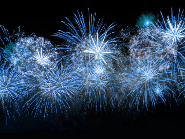Blue fireworks against a night sky