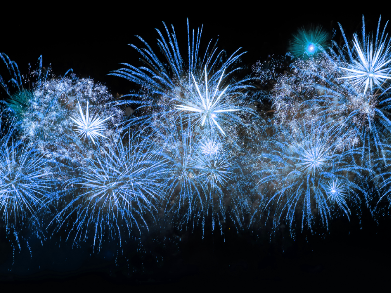 Blue fireworks against a night sky